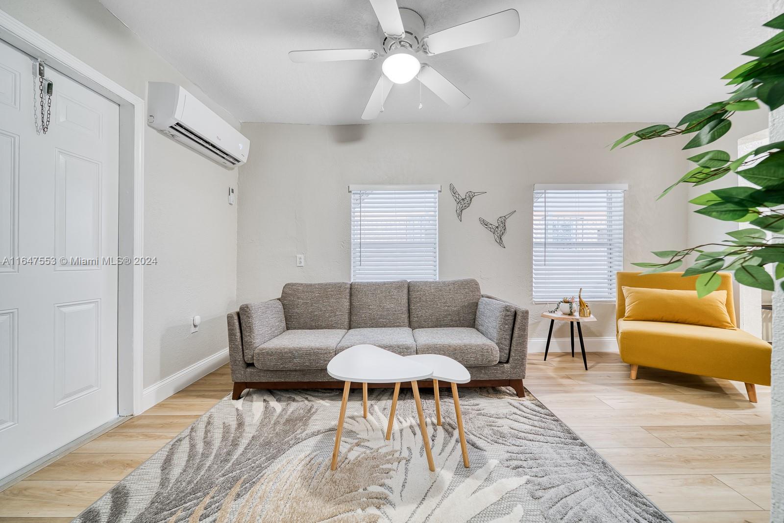 a living room with furniture and a potted plant