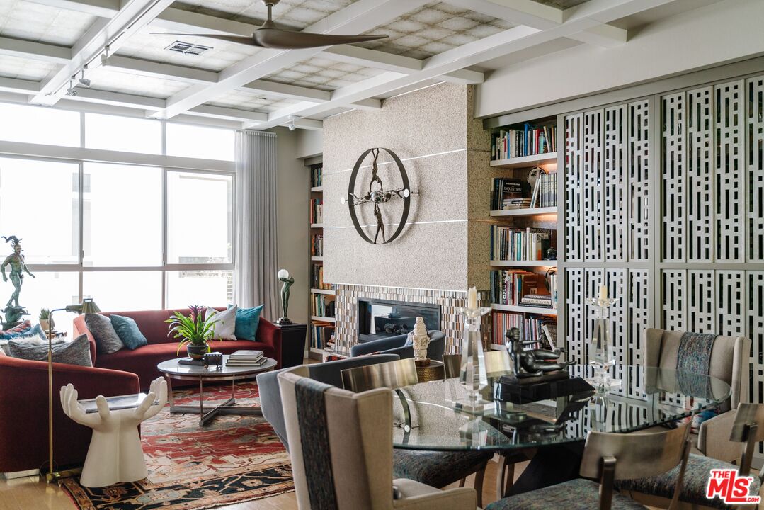 a living room with fireplace furniture and a large window