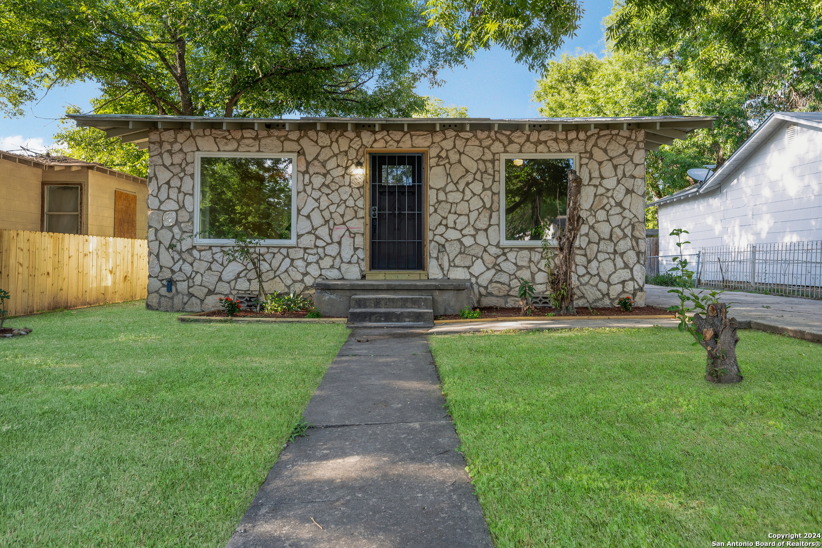 a front view of a house with garden