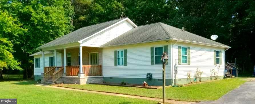 a view of a house with a yard and porch