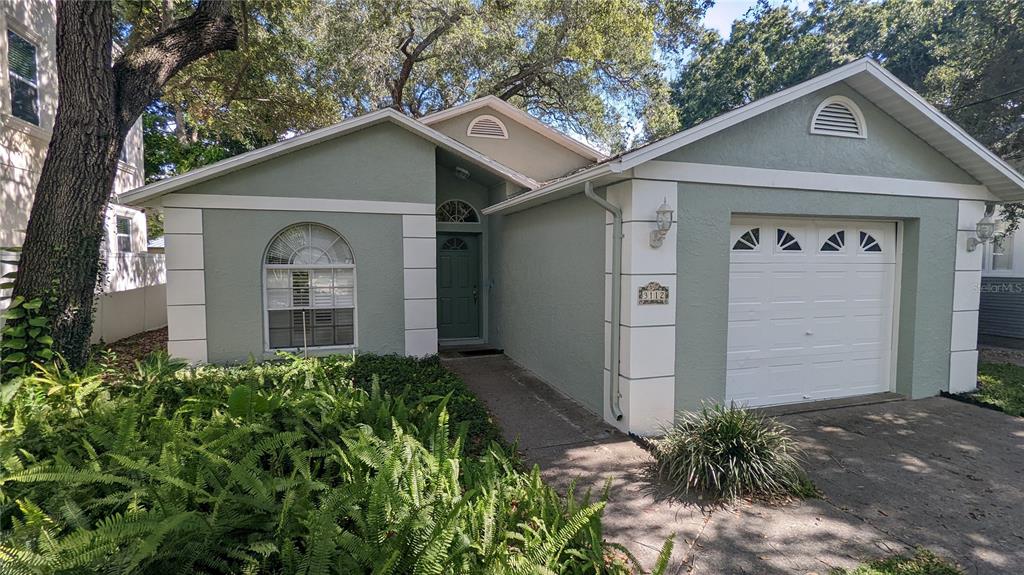 a view of a garage and a yard