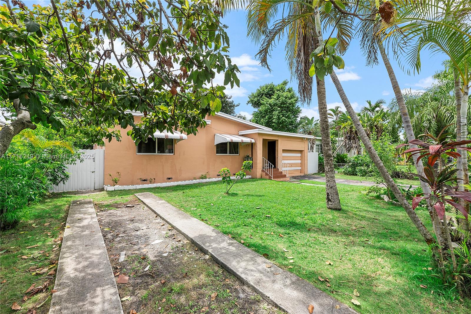 a view of backyard of house with green space