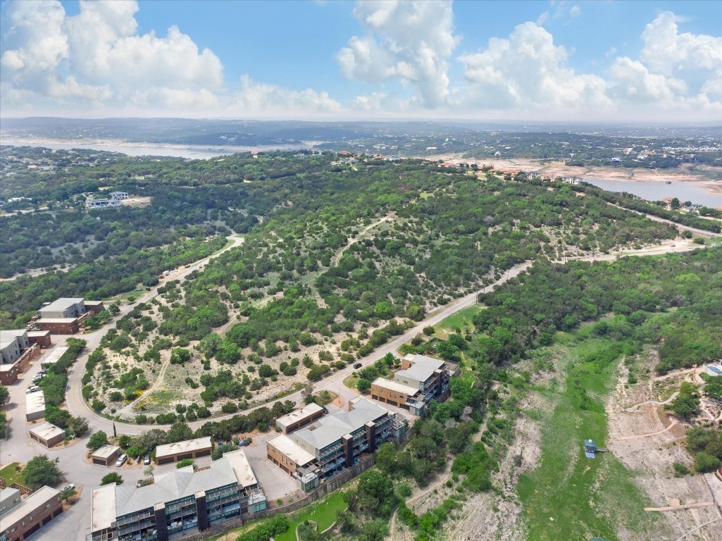 an aerial view of residential building with green space