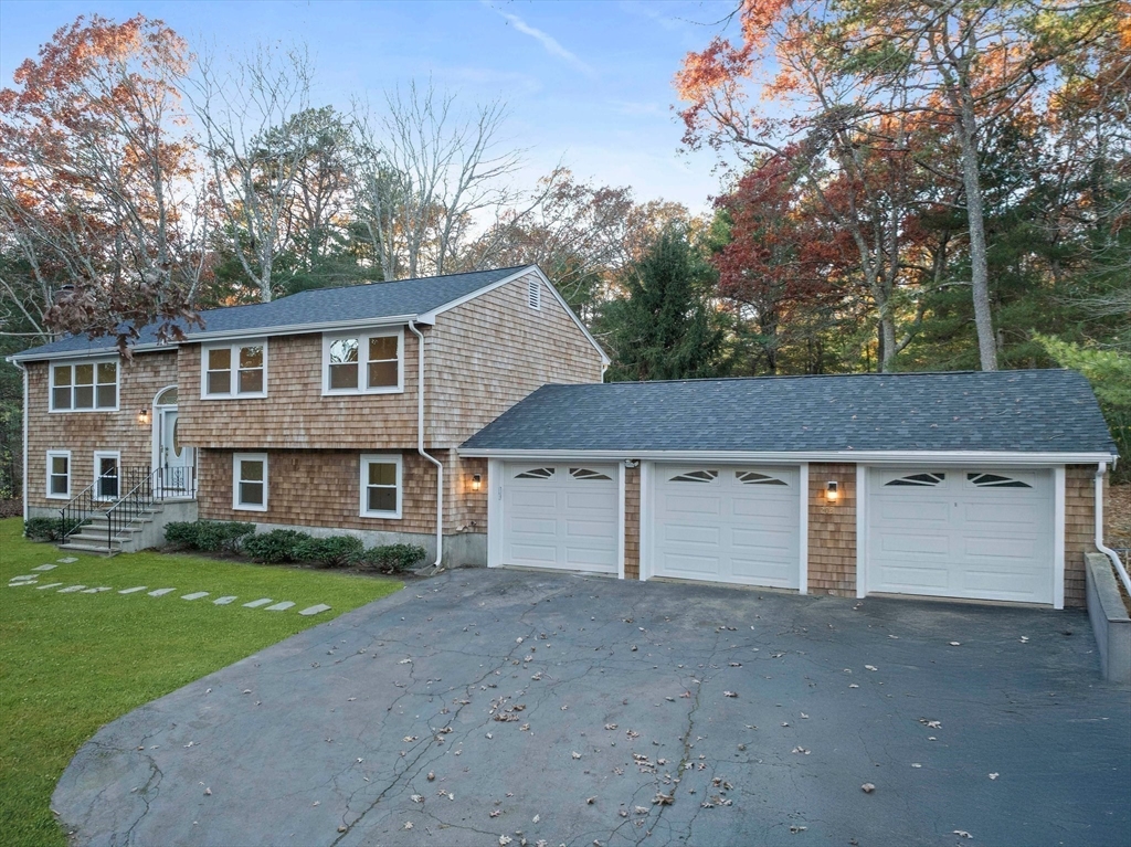 a front view of a house with a garden and yard