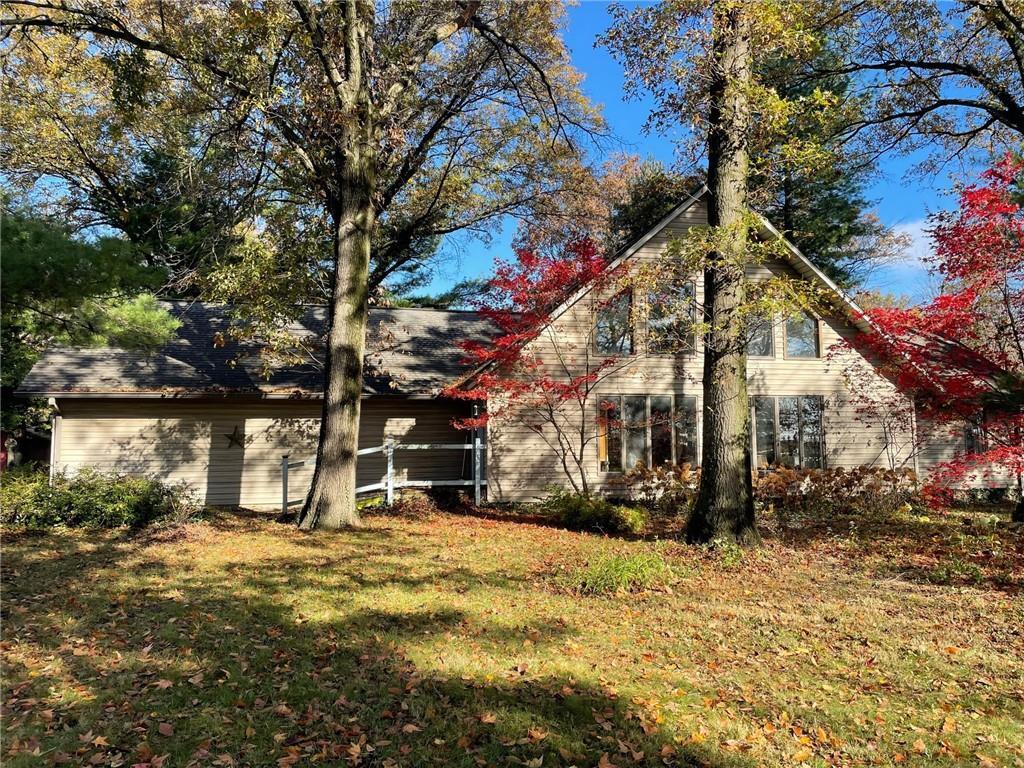 a view of a house with large trees