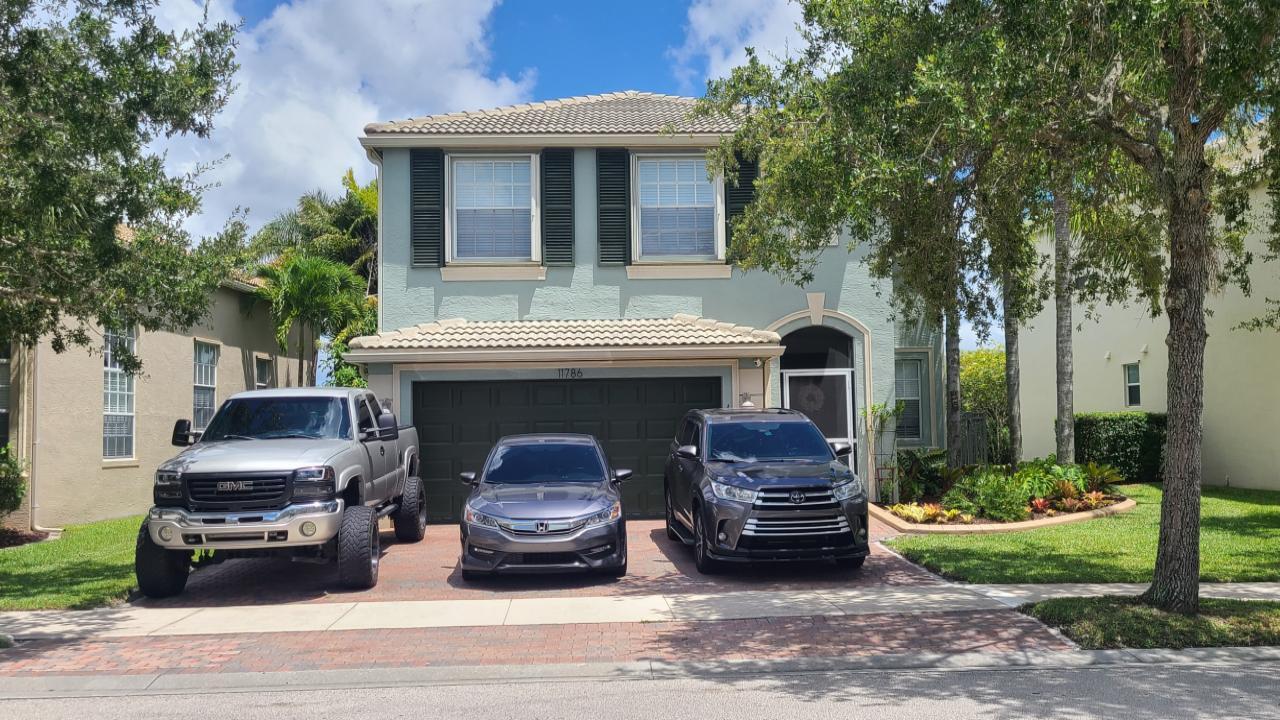 a view of a car parked in front of a house