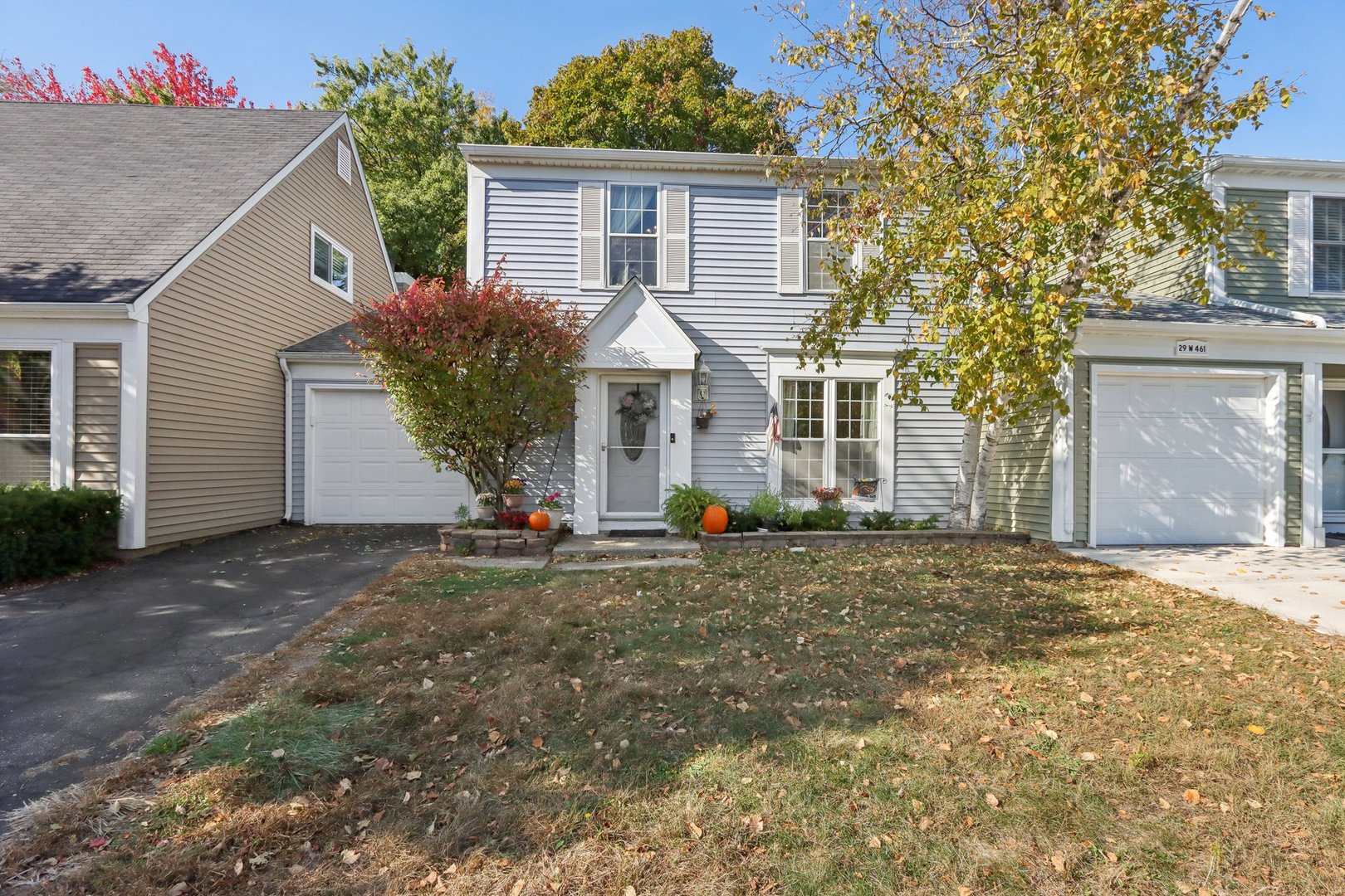 a view of a house with a yard and garage