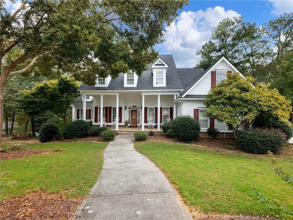 a front view of a house with yard and green space