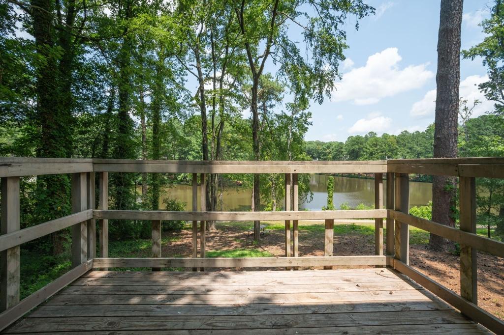 a view of a balcony with lake view and wooden floor