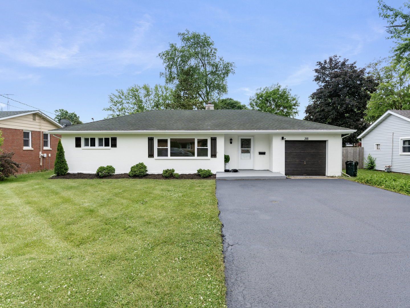 front view of a house with a yard