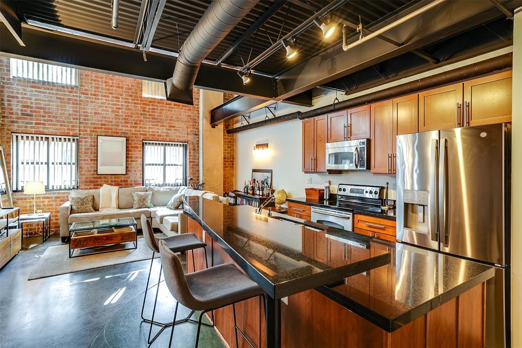 a kitchen with sink refrigerator and large window