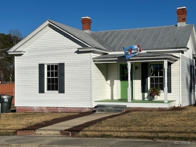 View of front of house with covered porch and a fr