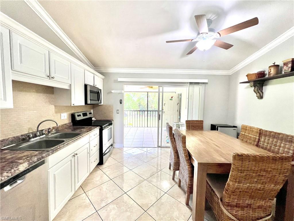 a kitchen with a table chairs and a refrigerator