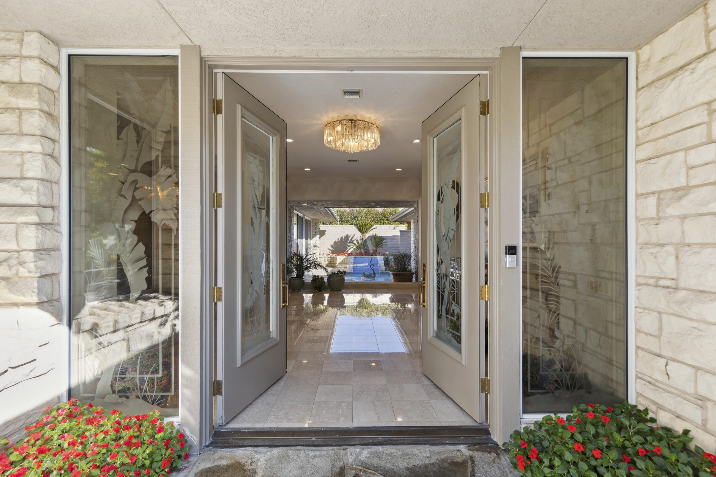 a view of a hallway with a dining room view with wooden floor and a livingroom view