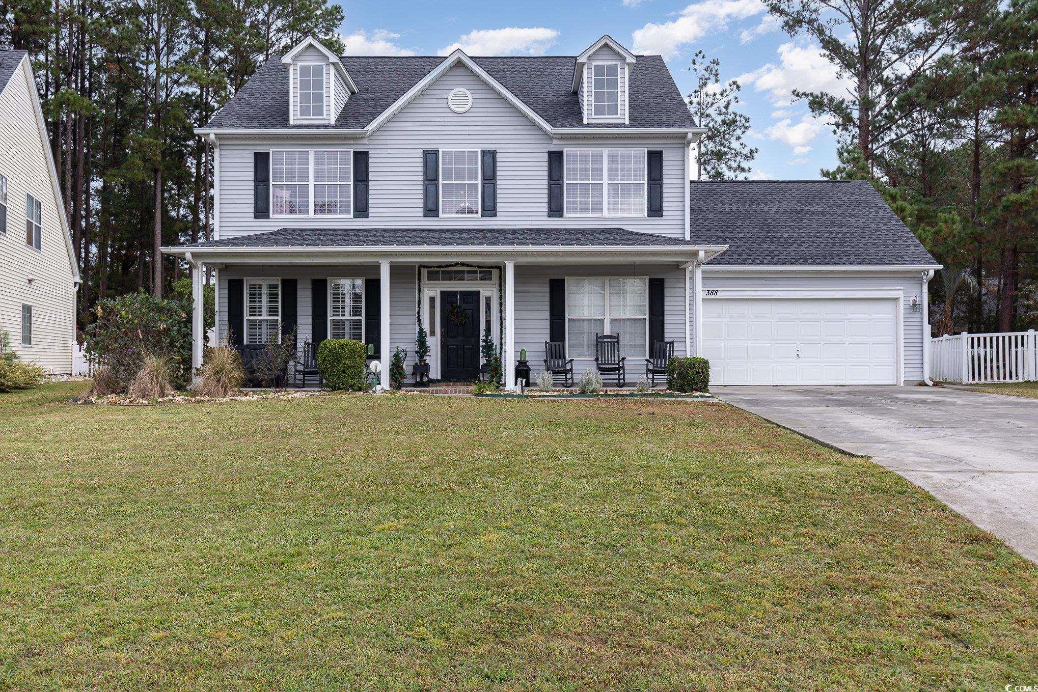 View of front of house featuring a porch, a garage