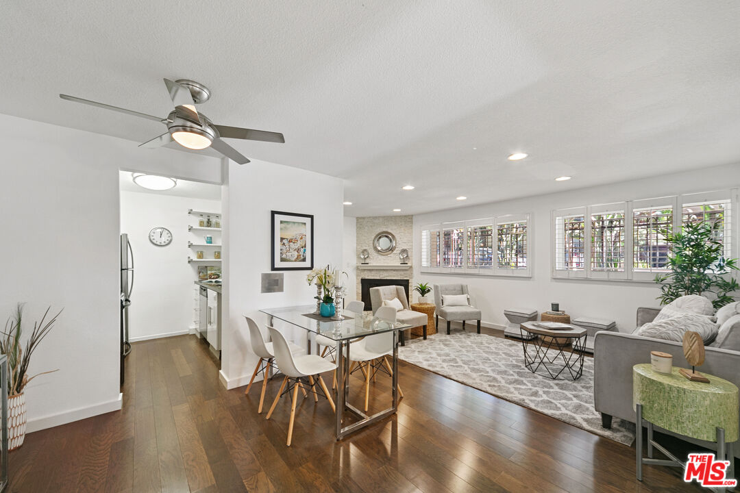 a living room with fireplace furniture and wooden floor