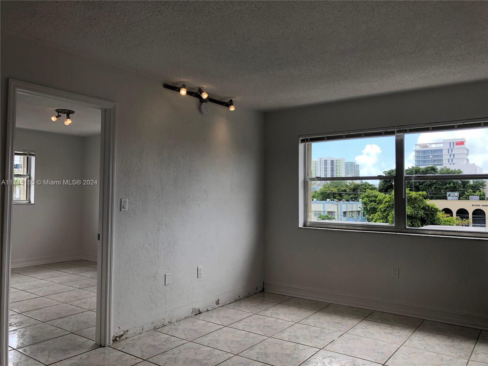 a view of an empty room with a window