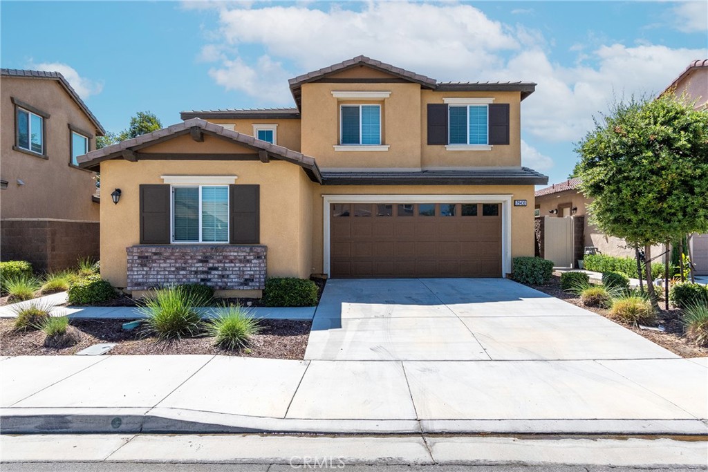 a front view of a house with a yard and garage