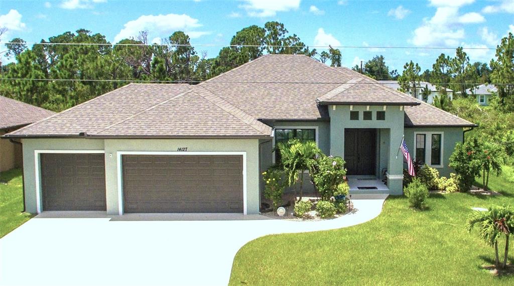 a front view of a house with a yard and garage