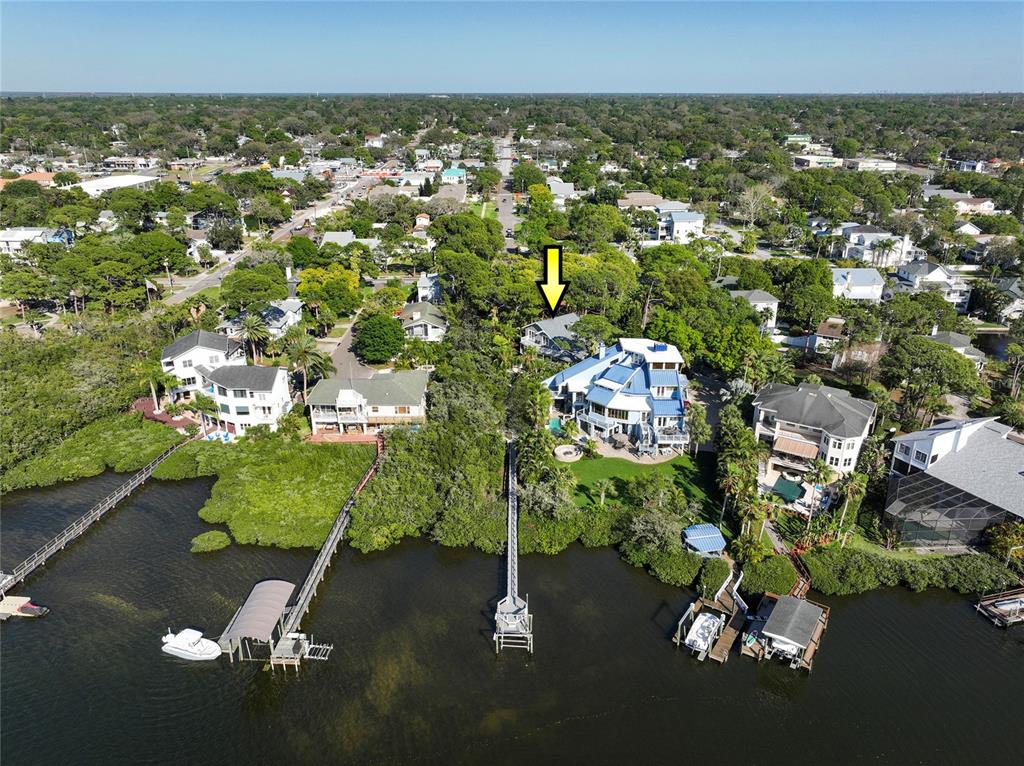 an aerial view of a house with a yard basket ball court and outdoor seating