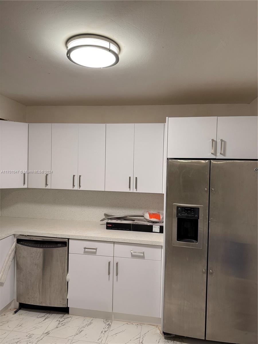 a kitchen with cabinets and appliances