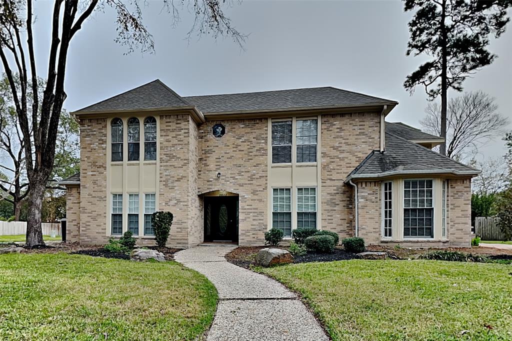 a front view of a house with a garden and yard