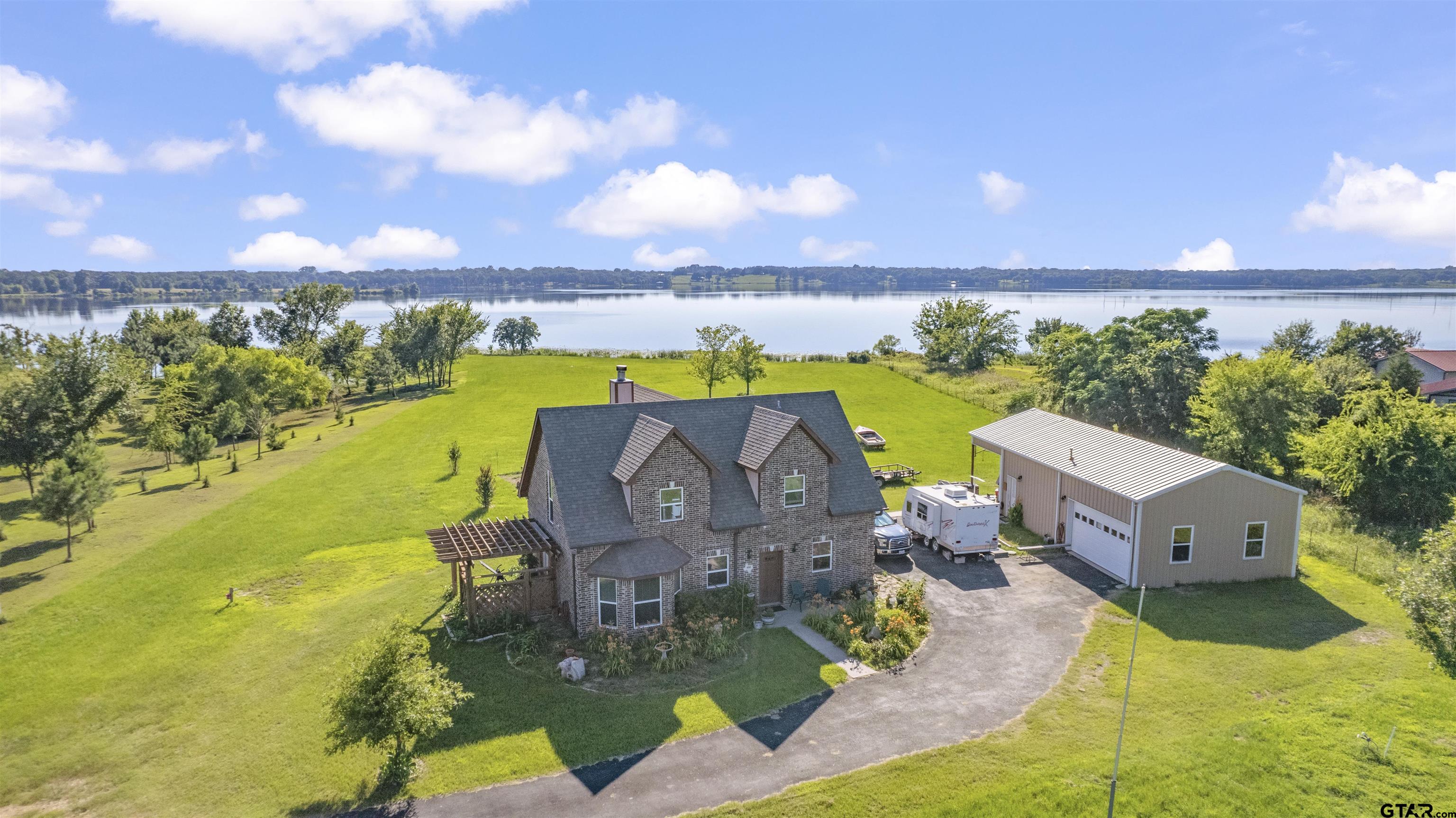 an aerial view of a house with a ocean view