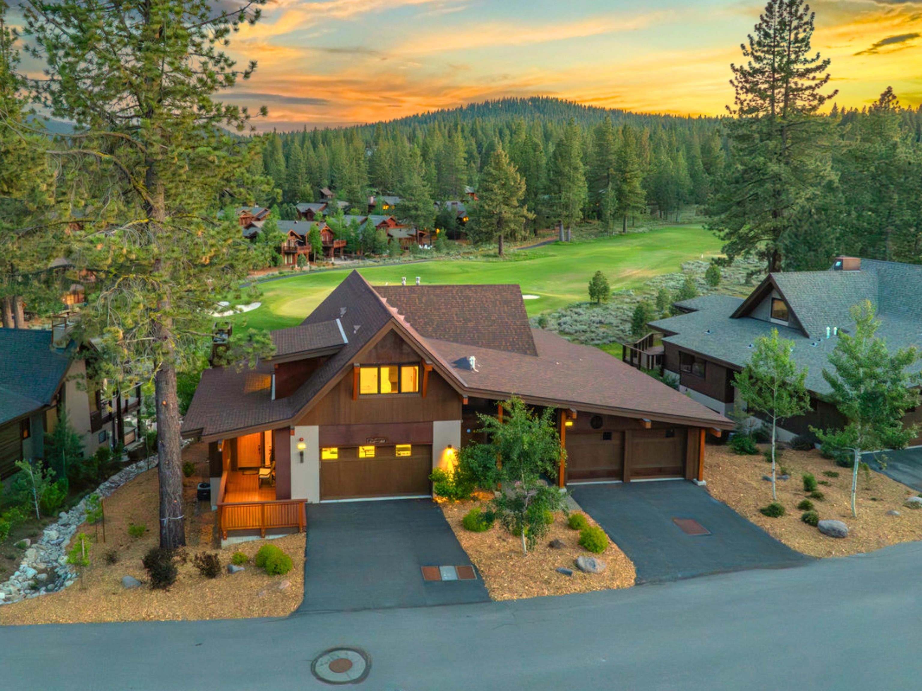 an aerial view of a house with garden space and street view