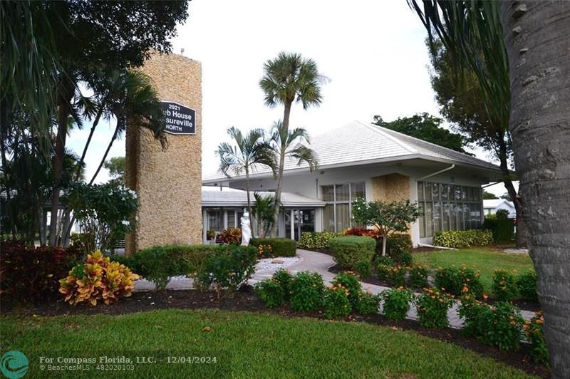 a front view of a house with a garden and plants