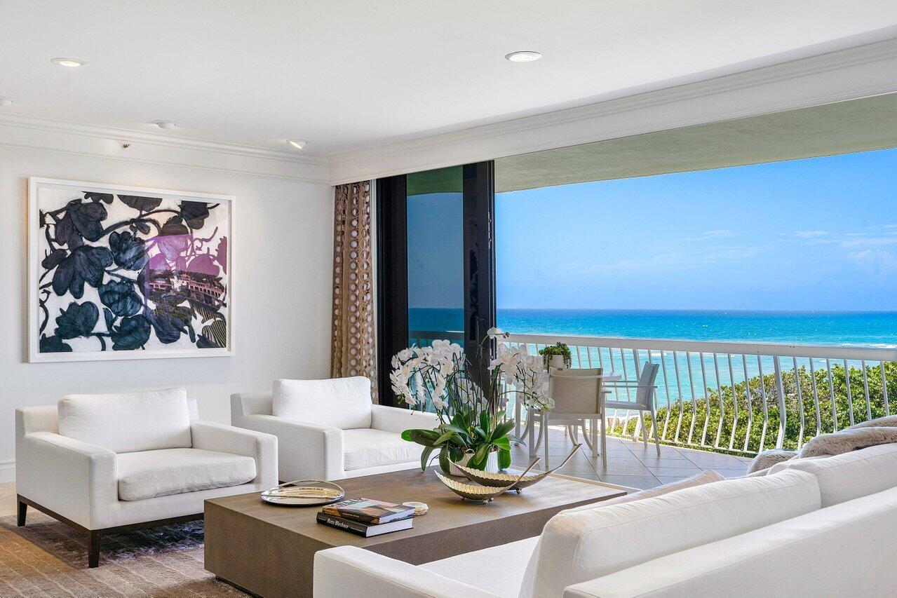 a living room with furniture ceiling fan and a rug