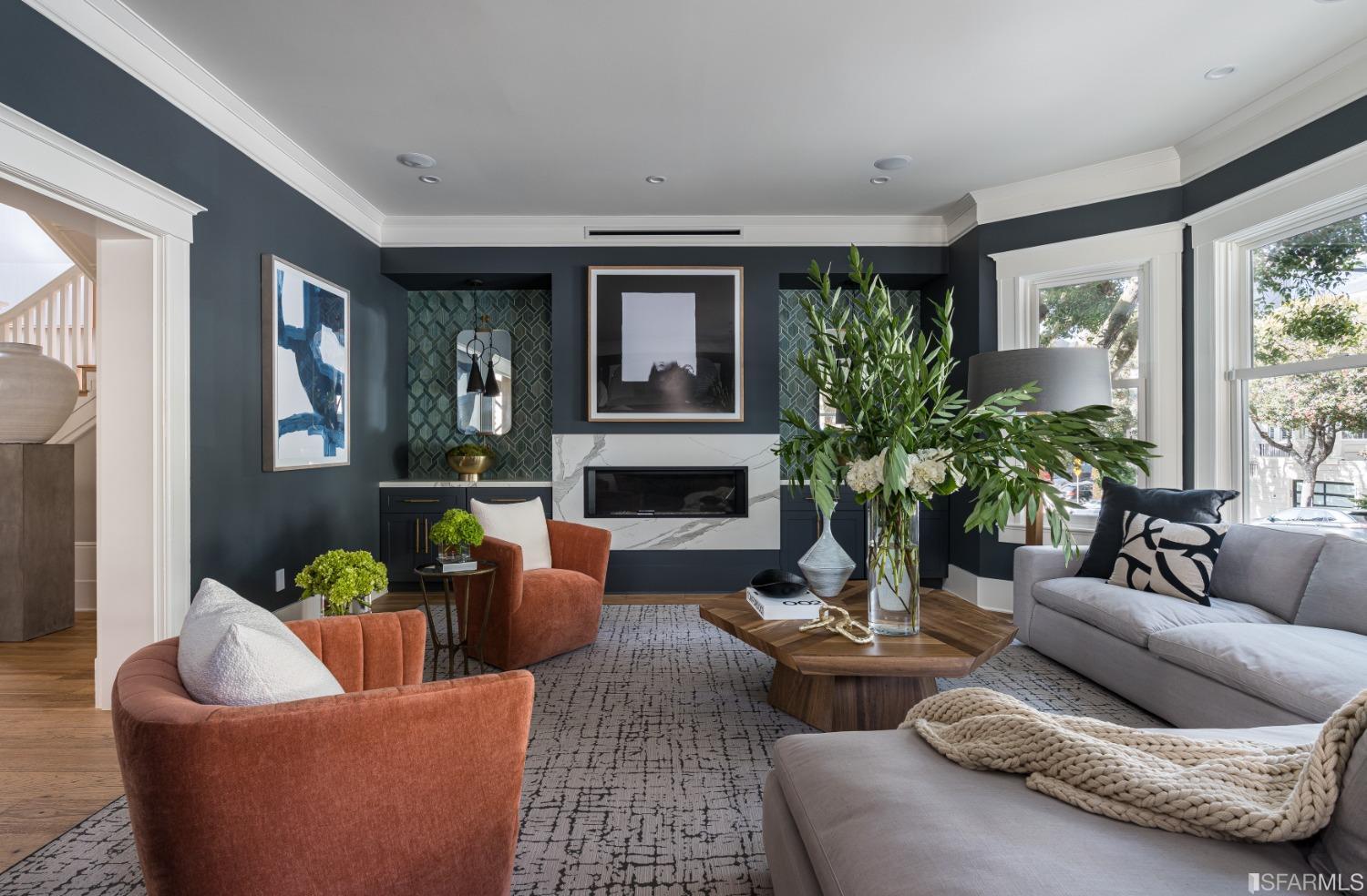 a living room with furniture and a potted plant