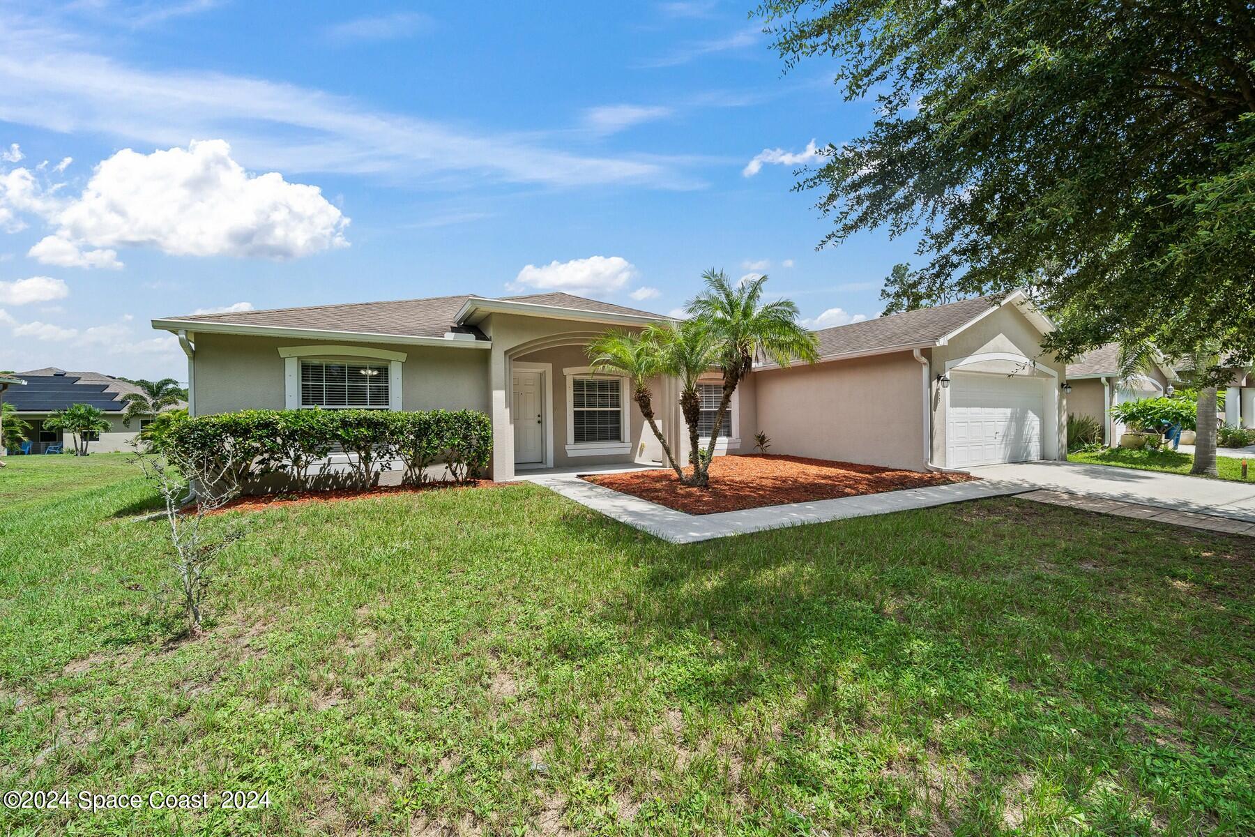 a front view of house with yard and outdoor seating