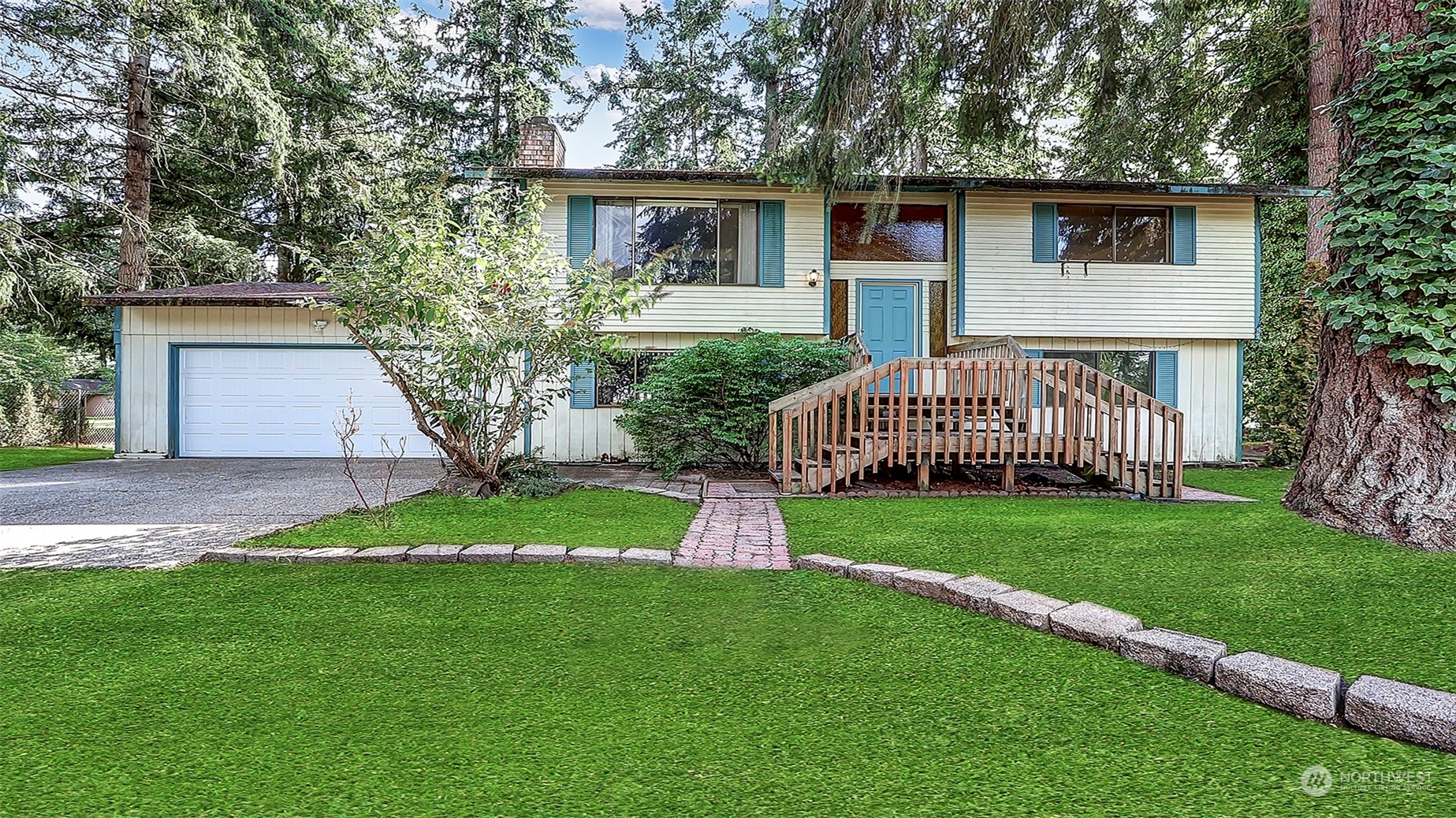 a front view of a house with a yard and trees