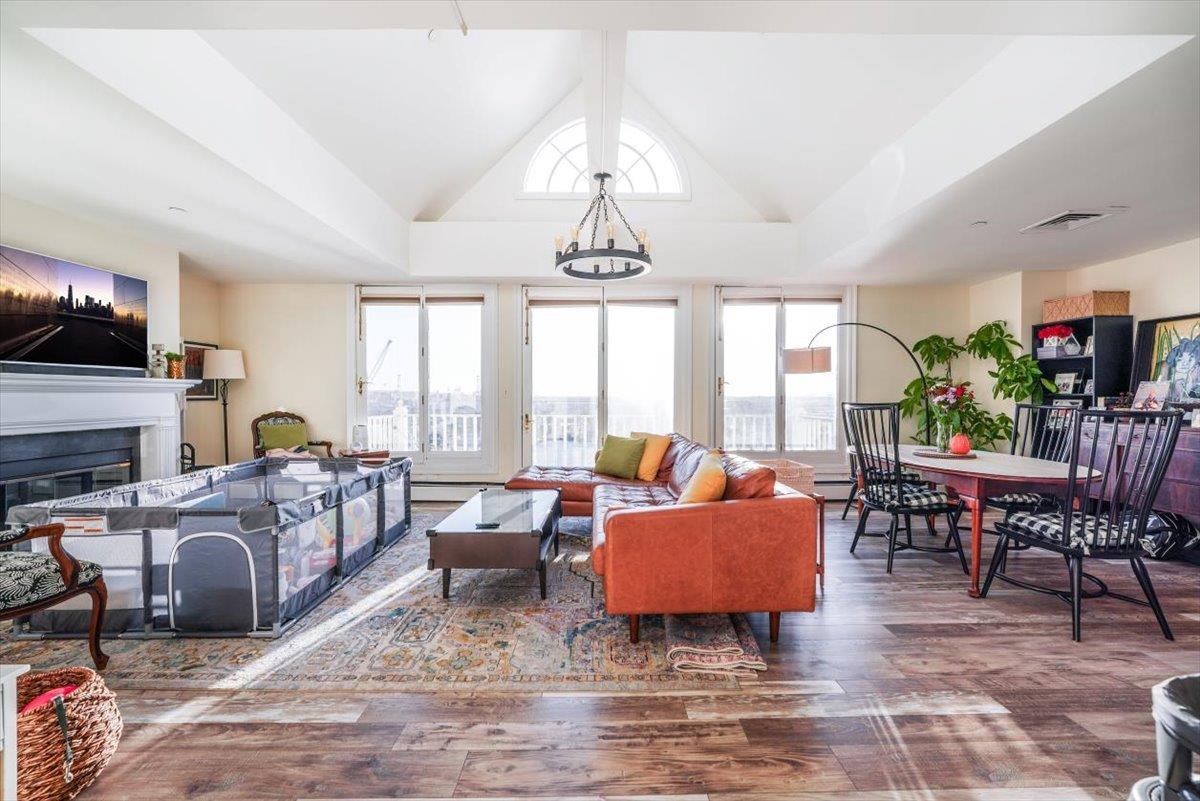 a living room with fireplace furniture and a large window