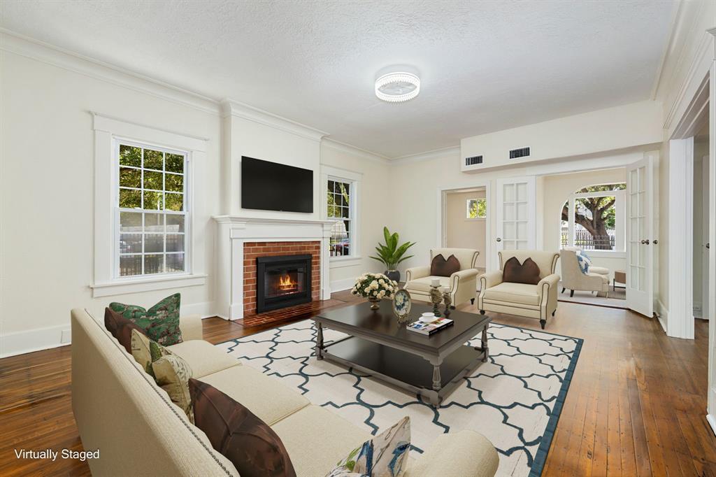 a living room with furniture a fireplace and a flat screen tv