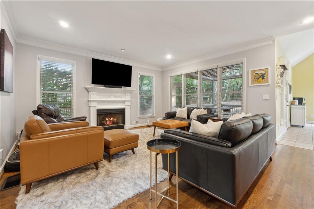 a living room with furniture a flat screen tv and a fireplace