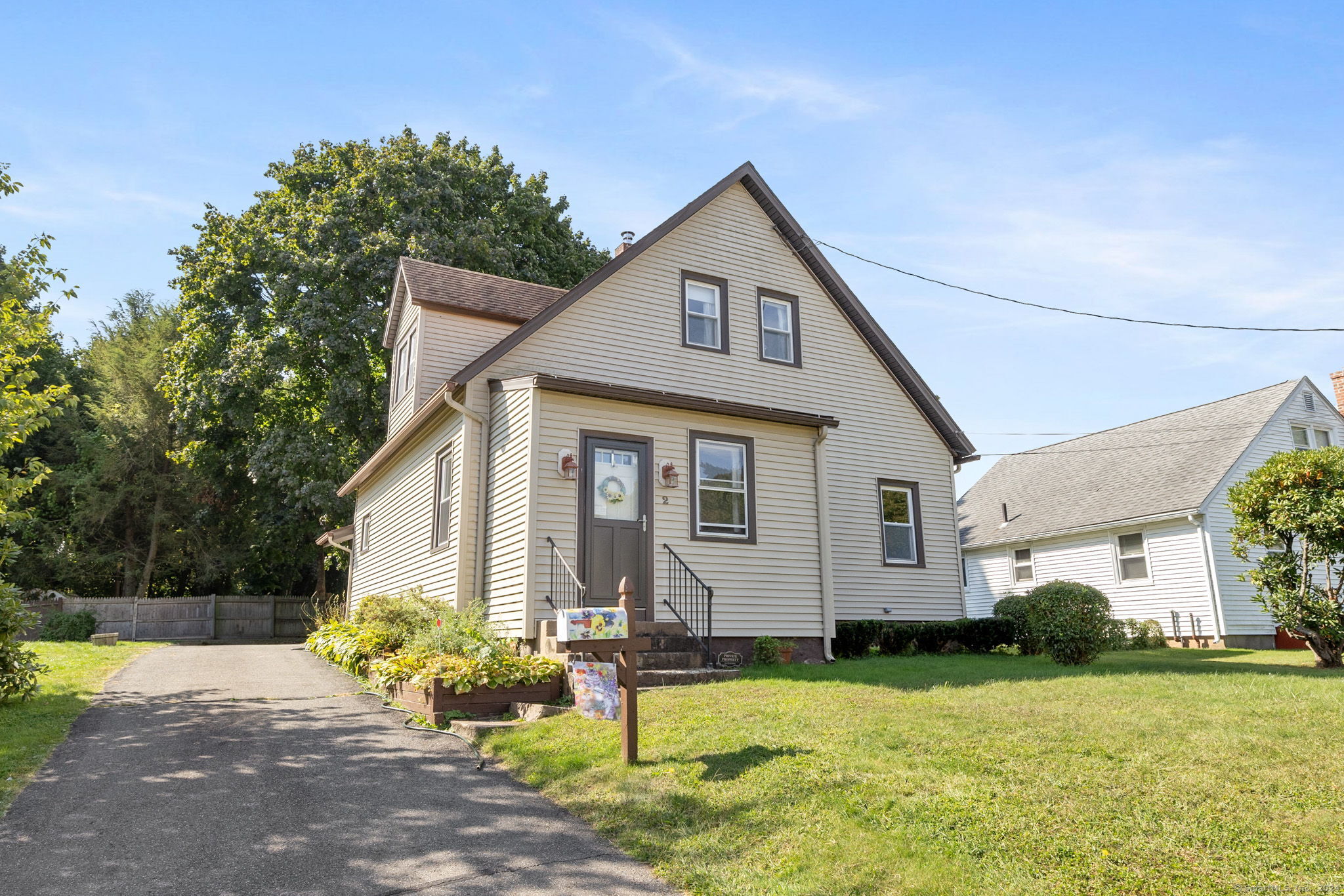 a front view of house with yard and green space