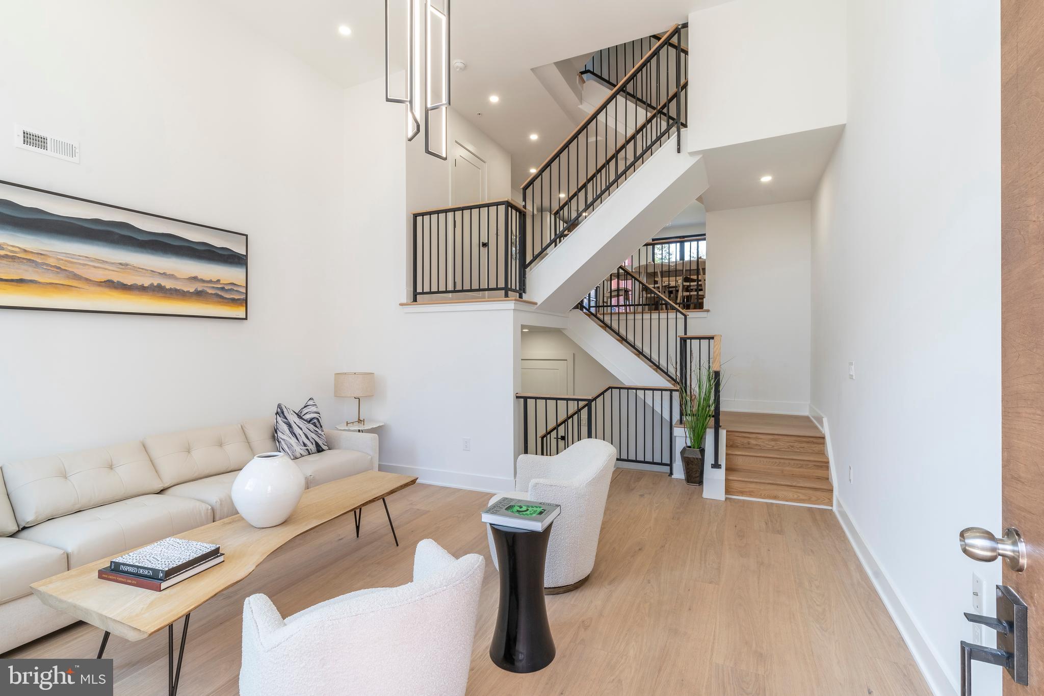 a living room with furniture and stairs