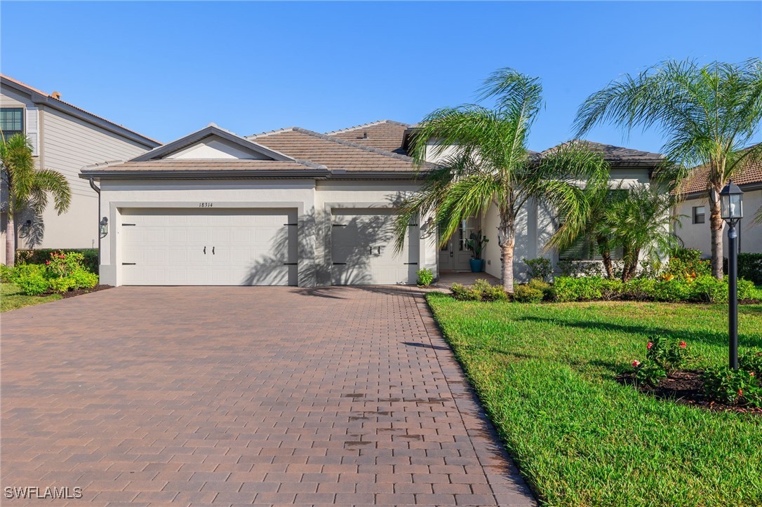 a front view of a house with a yard and garage