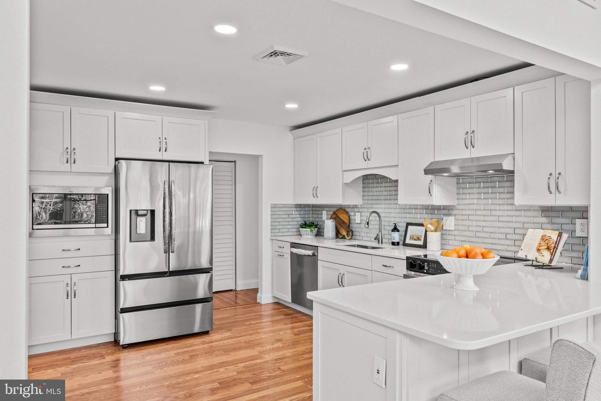 a kitchen with stainless steel appliances a refrigerator sink and cabinets