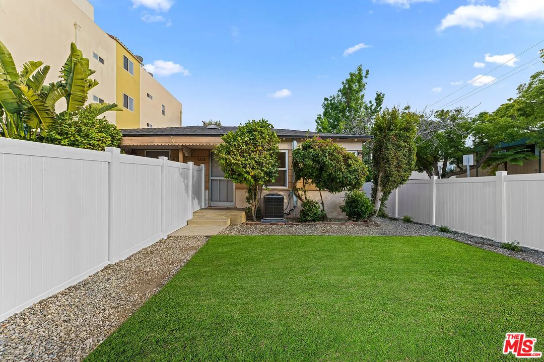 a view of a house with a yard and sitting area