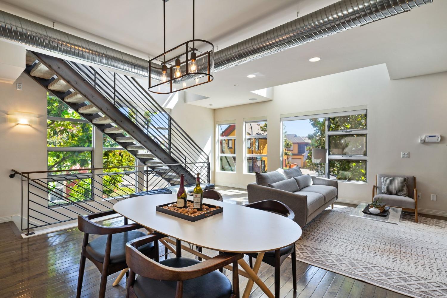 a living room with furniture a window and a chandelier