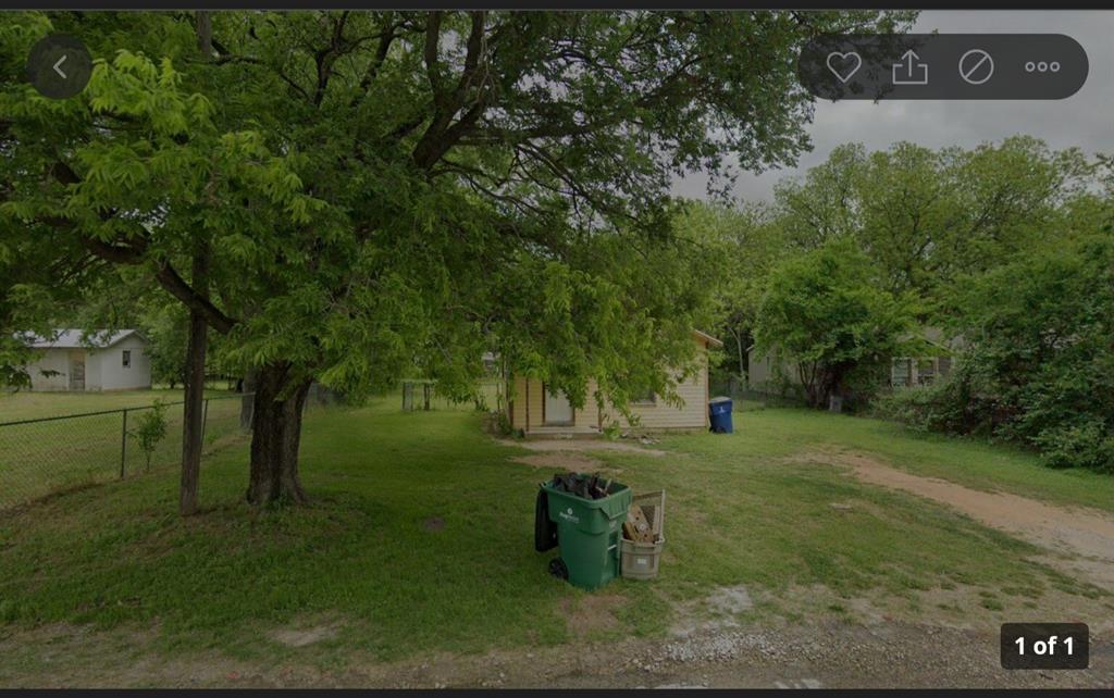 a view of a park that has large trees