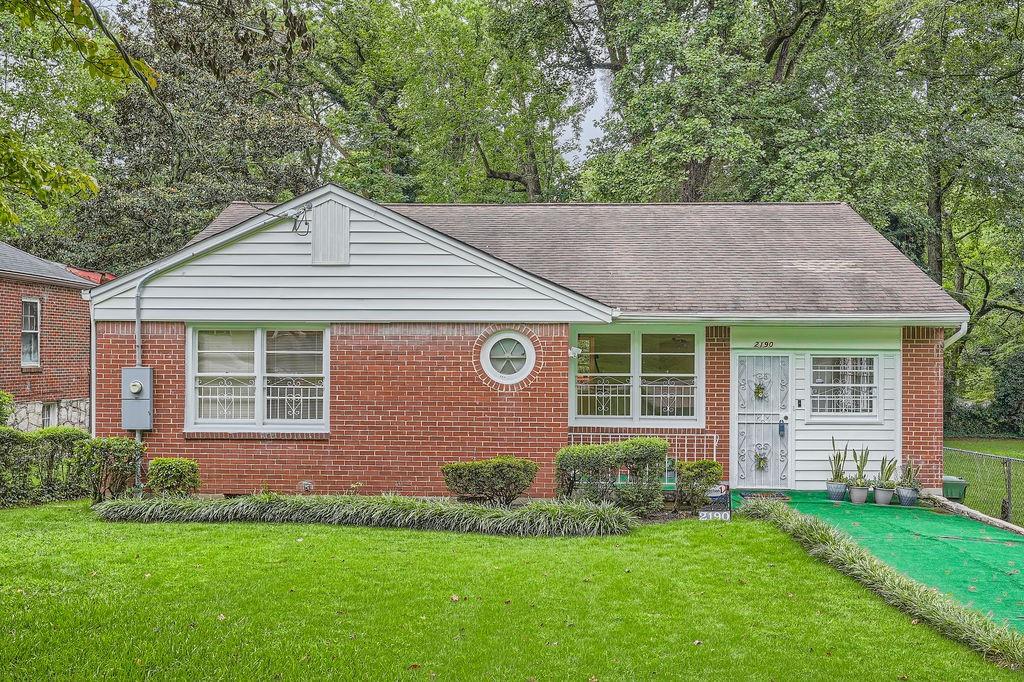 a front view of a house with a yard and porch