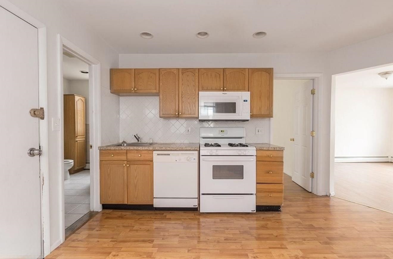 a kitchen with stainless steel appliances a stove a sink and a refrigerator