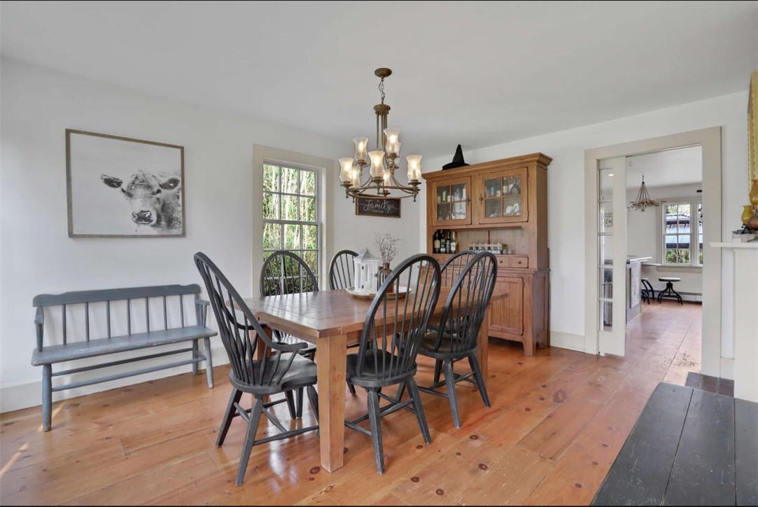 Dining space featuring light wood-type flooring and a notable chandelier