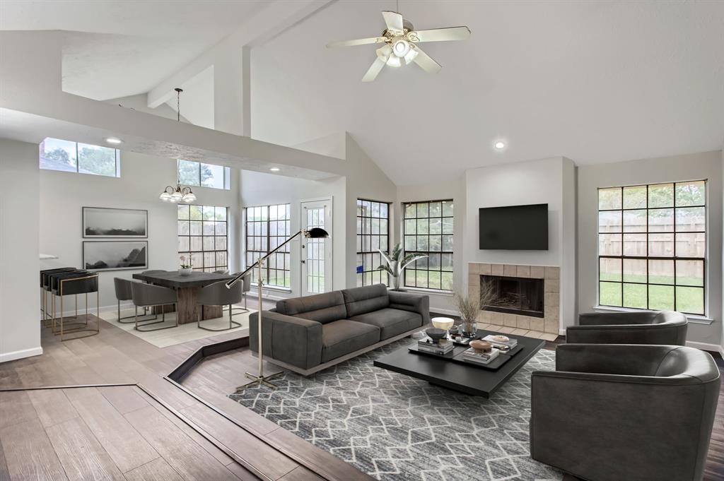 a living room with furniture a fireplace and a flat screen tv