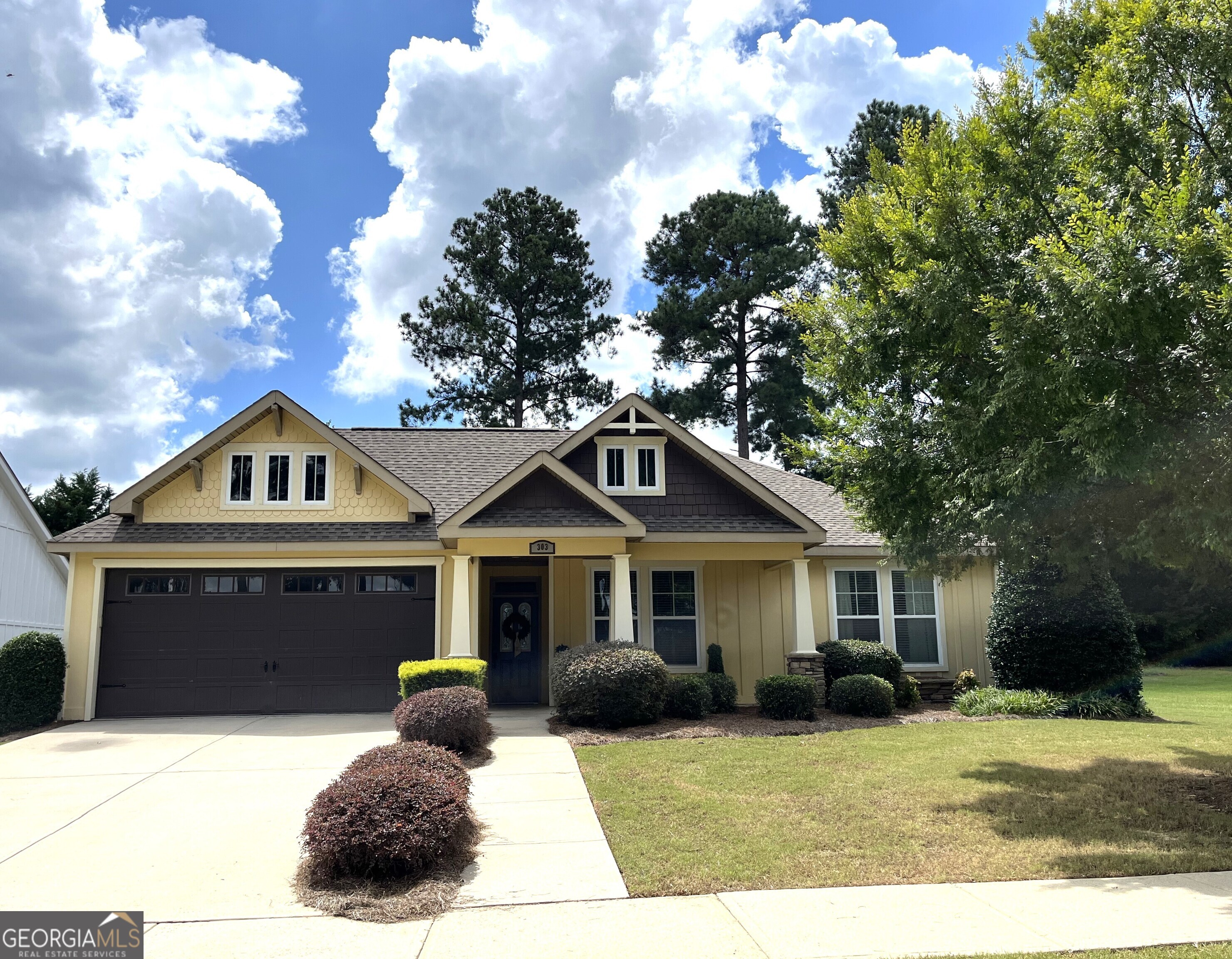 a front view of a house with a garden