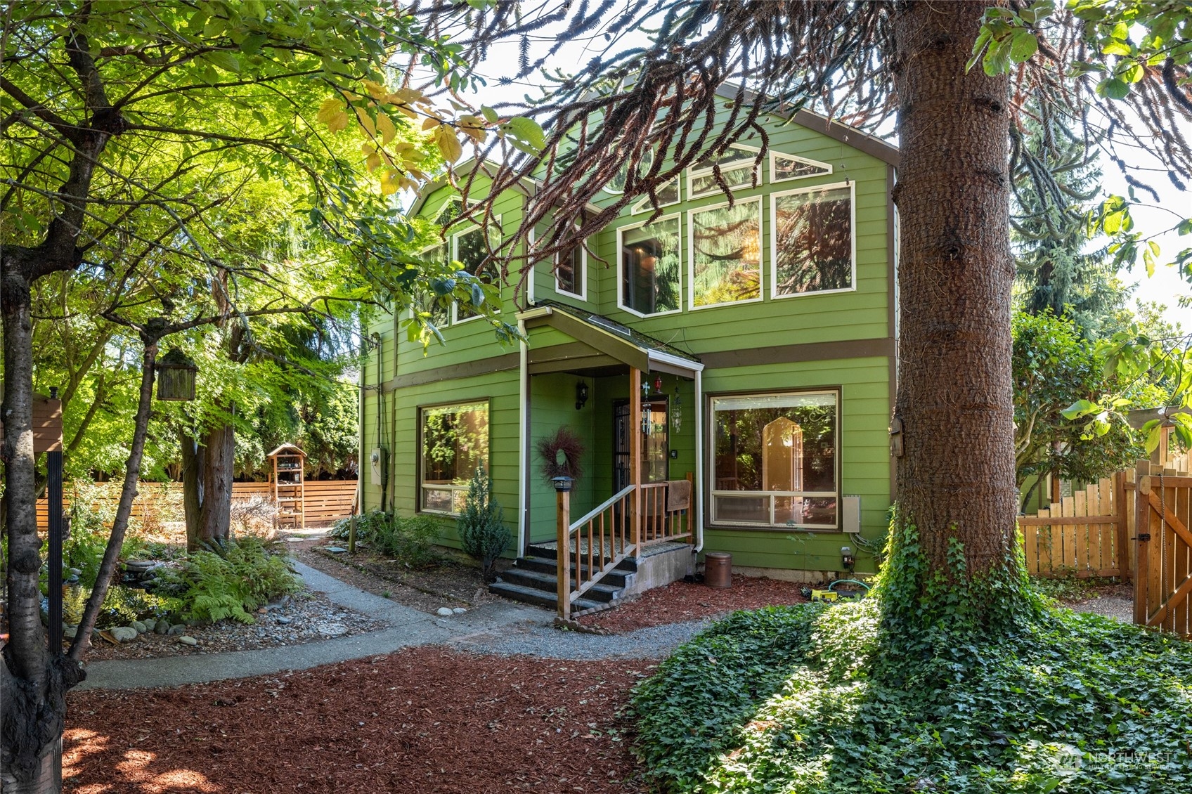 front view of a house with a tree in front of it