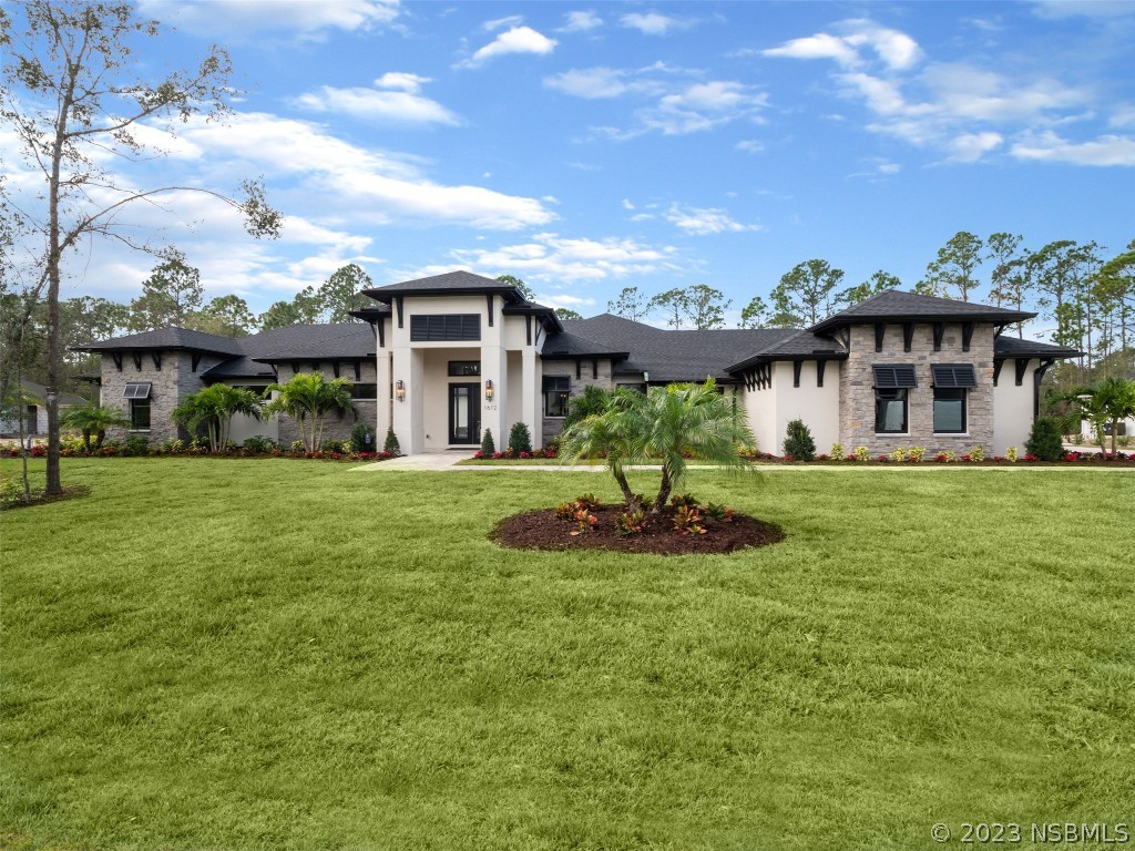 a front view of a house with a yard